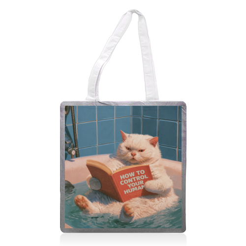 A white cat reading book "How to control your human - printed canvas tote bag by DejaReve