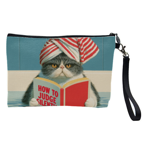 A cat reading book about Judging - pretty makeup bag by DejaReve